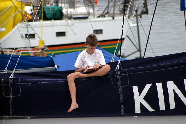 Boy reading on boat in Knysna