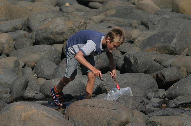 Boy busy searching something on the beach - we couldn&amp;acute;t figure out what he was looking for!