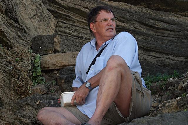 Karl with [url=http://www.geocaching.com/]geocache[/url]  - looking around to avoid being seen by "muggles"