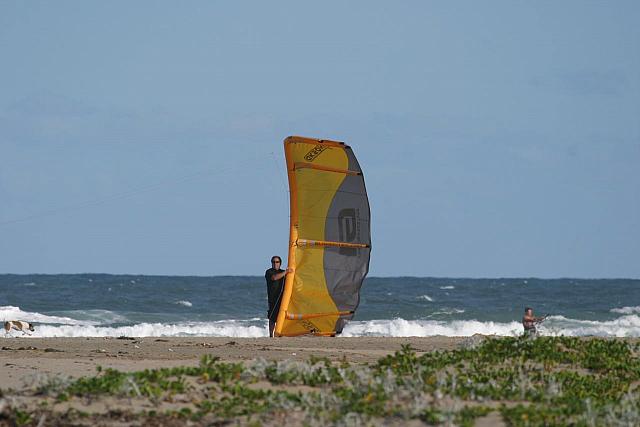 Man holding kite for kitesurfers