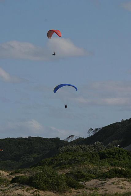 Two paragliders gliding above Nahoon beach