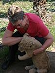 Maria petting a lion